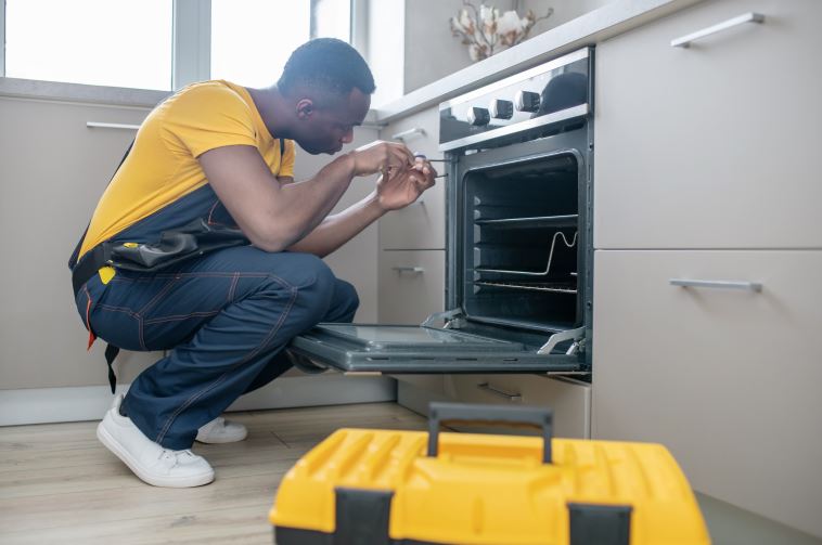A repairman performing overn repair in Edmont Canada
